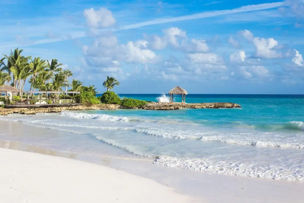 Eden Roc Beach Club beach with a thatched gazebo on the rocky point, Cap Cana, Dominican Republic