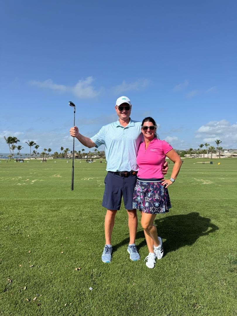 Robert and Kelly Bender on the Punta Espada golf course at Cap Cana, Robert holding a golf club