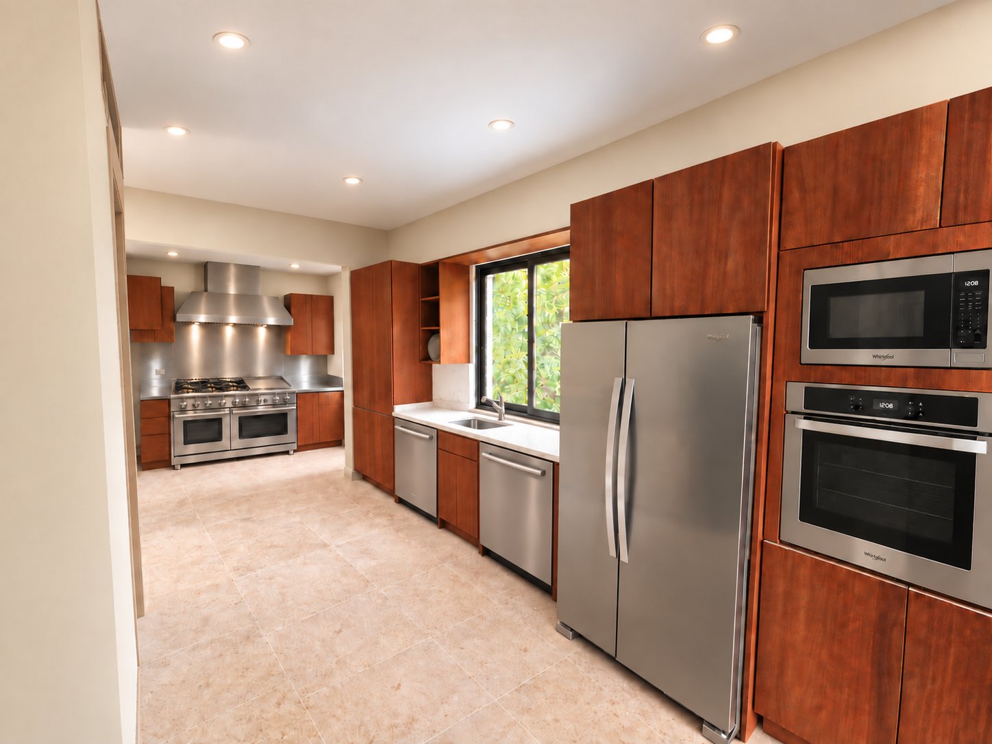 Villa Espada chef's kitchen with double refrigerator, wall oven and view to the commercial range, Cap Cana