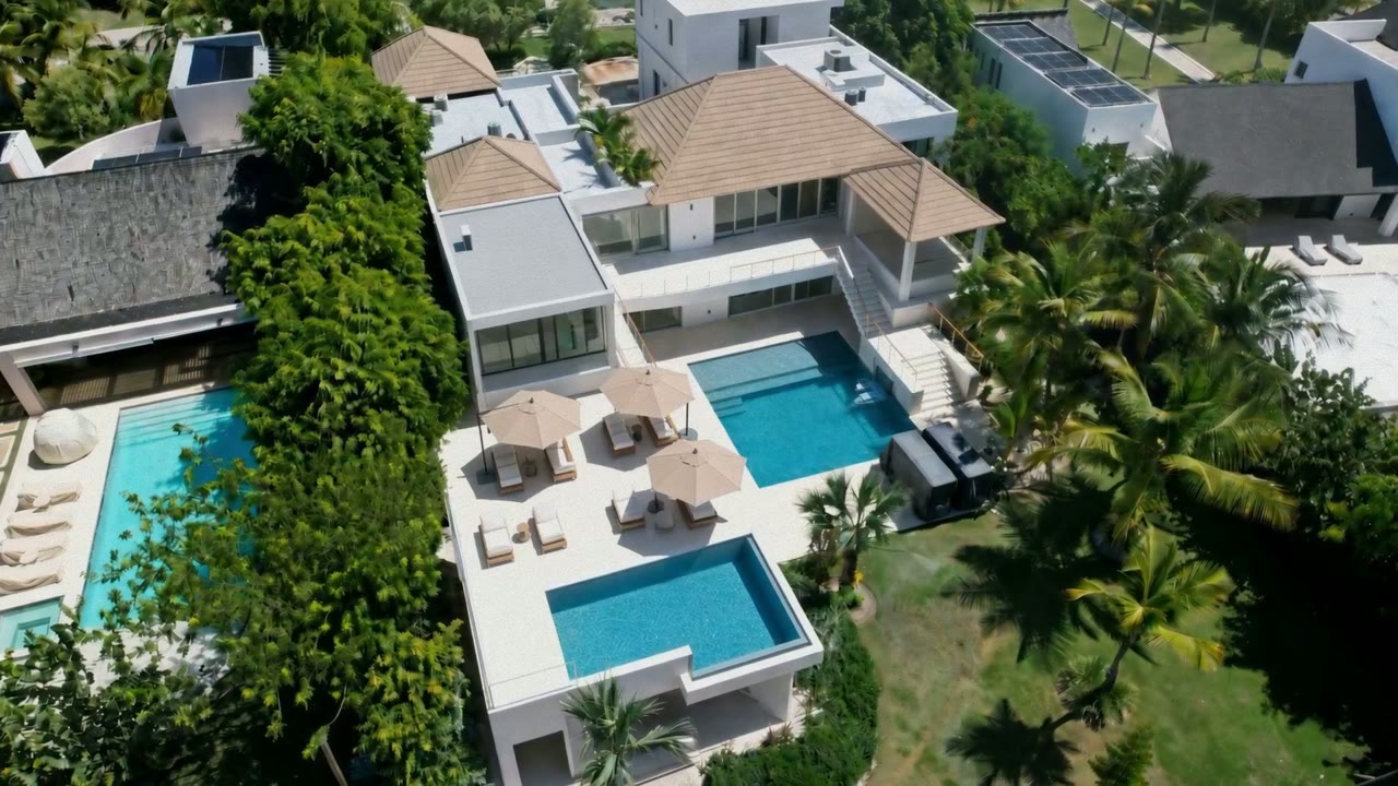Aerial view of Villa Espada's pools and terraces beside Punta Espada Golf Course, Cap Cana